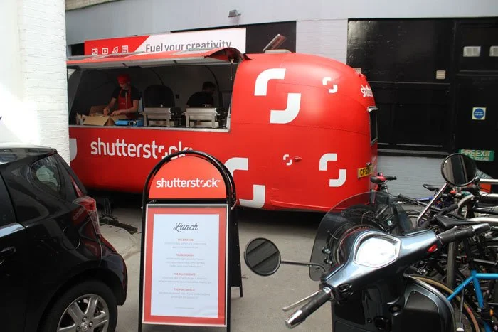 Airstream trailer being fully branded and customised for Shutterstock before being used for a branded pop-up activation with visitors interacting at the event.