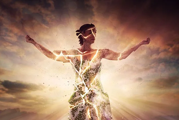 Woman standing with raised arms, surrounded by glowing cracks and light rays in a serene background.