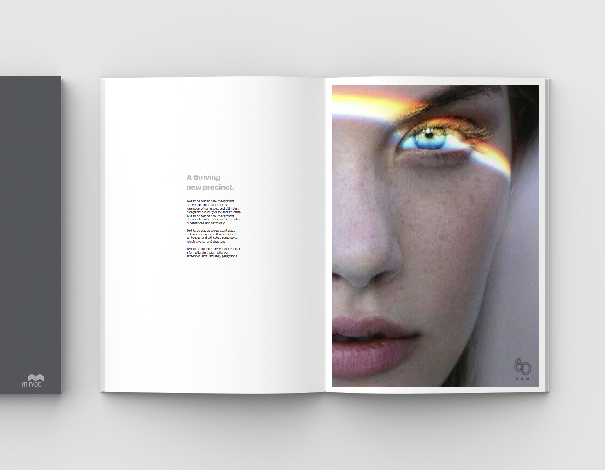 An open magazine with a close-up photograph of a woman's face on the right page. The woman has blue eyes, makeup, and a rainbow light effect across her face. The left page contains placeholder text and a headline about a thriving new precinct.