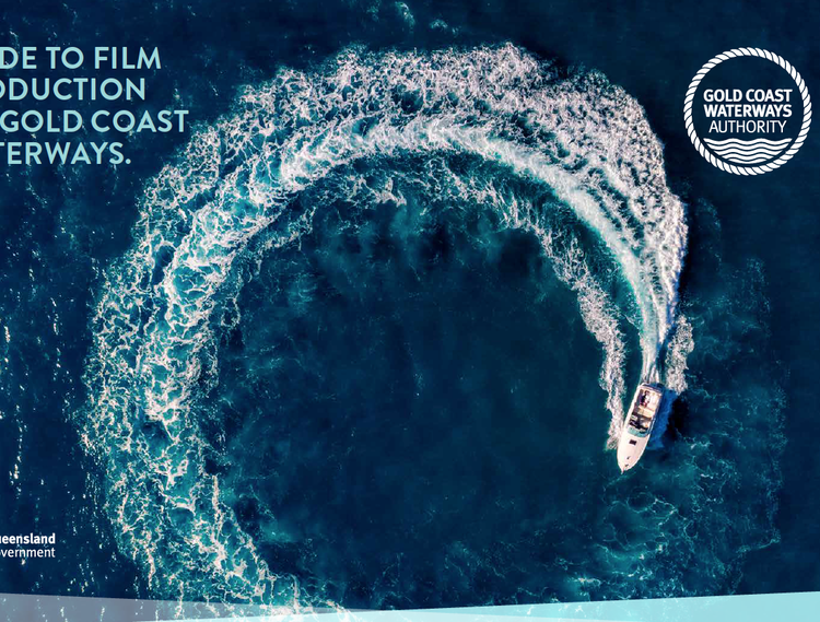 A boat creates a large circular wake in the ocean, viewed from above, with text and logo related to Gold Coast Waterways Authority.