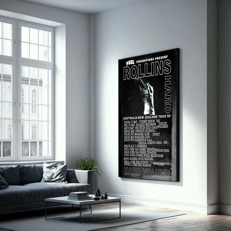 Postering of the band Rollins Hard performing a tour in Australia and New Zealand, with tour dates listed, on a black background in a minimalist living room with a sofa and large window.