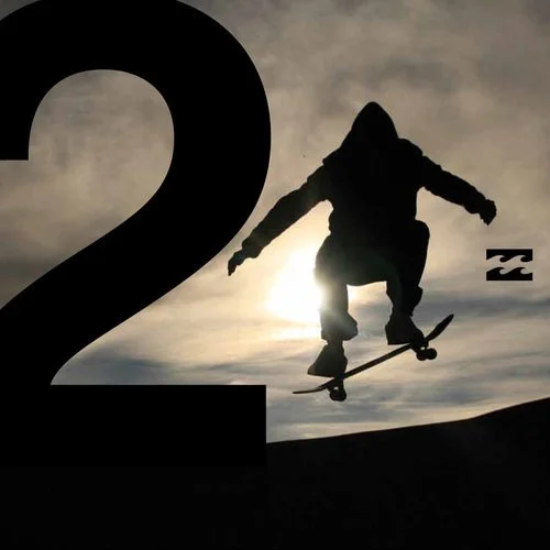 Silhouette of a skateboarder performing a jump against a cloudy sky at sunset, with a large black number 2 on the left side.