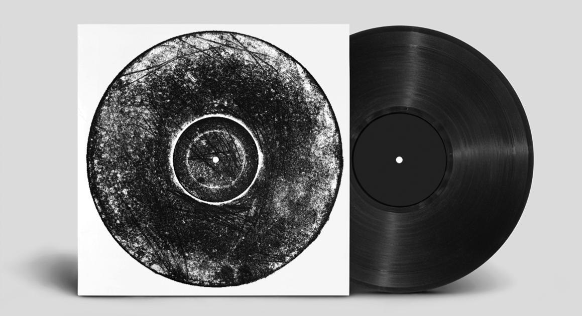 A vinyl record and its album cover are shown, with the cover featuring a black and white abstract circular design resembling a tree or forest.