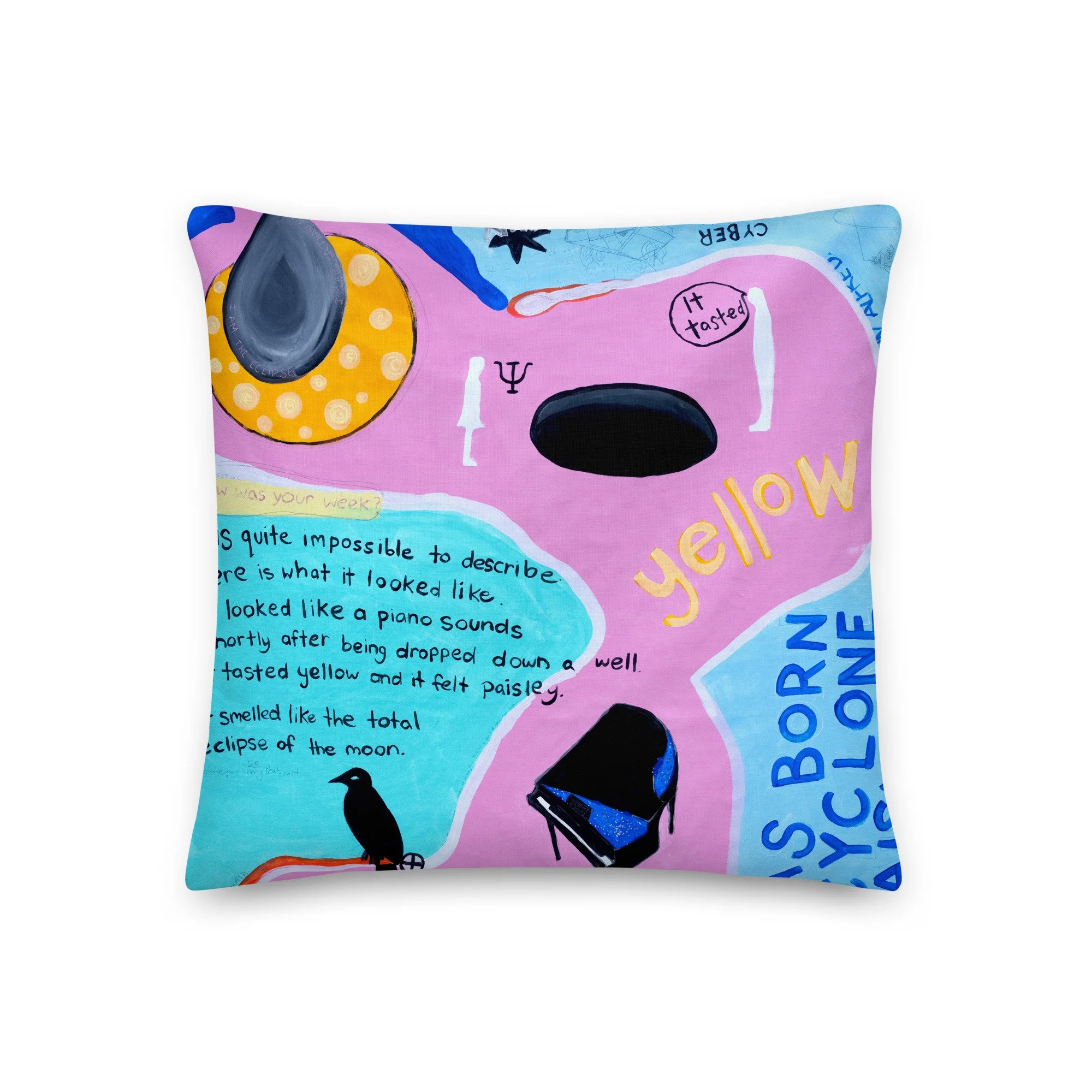 Decorative pillow with hand-painted abstract art and handwritten text in pink, yellow, blue, and black colors, featuring images of a piano, a crow, and text about a yellow color.