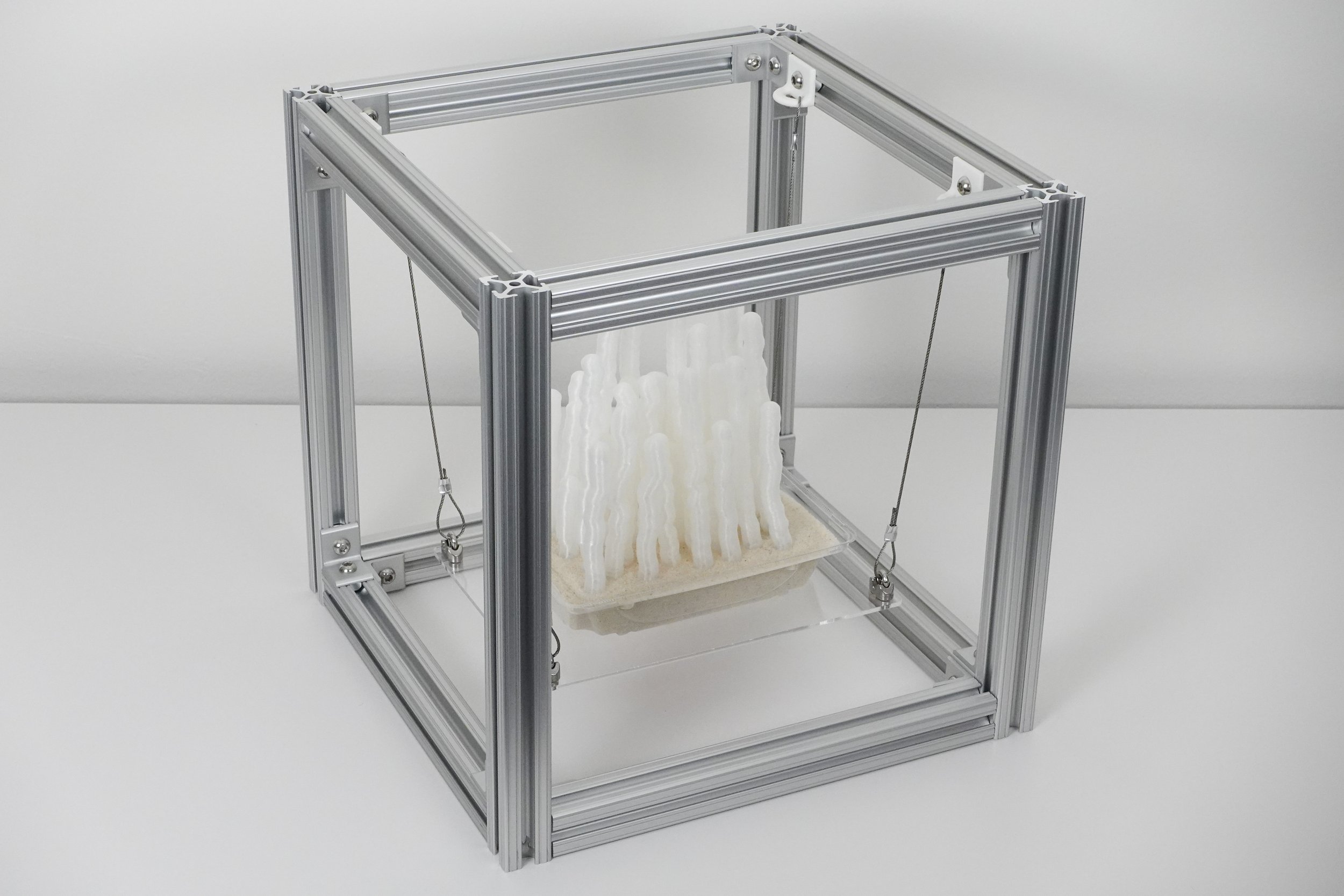 Microstachys Filiformis, 2025. 3D printed polylactic acid, recycled polyethylene terephthalate, aluminum extrusion, steel cable, acrylic, sand, 12 x 12 x 12 in.
