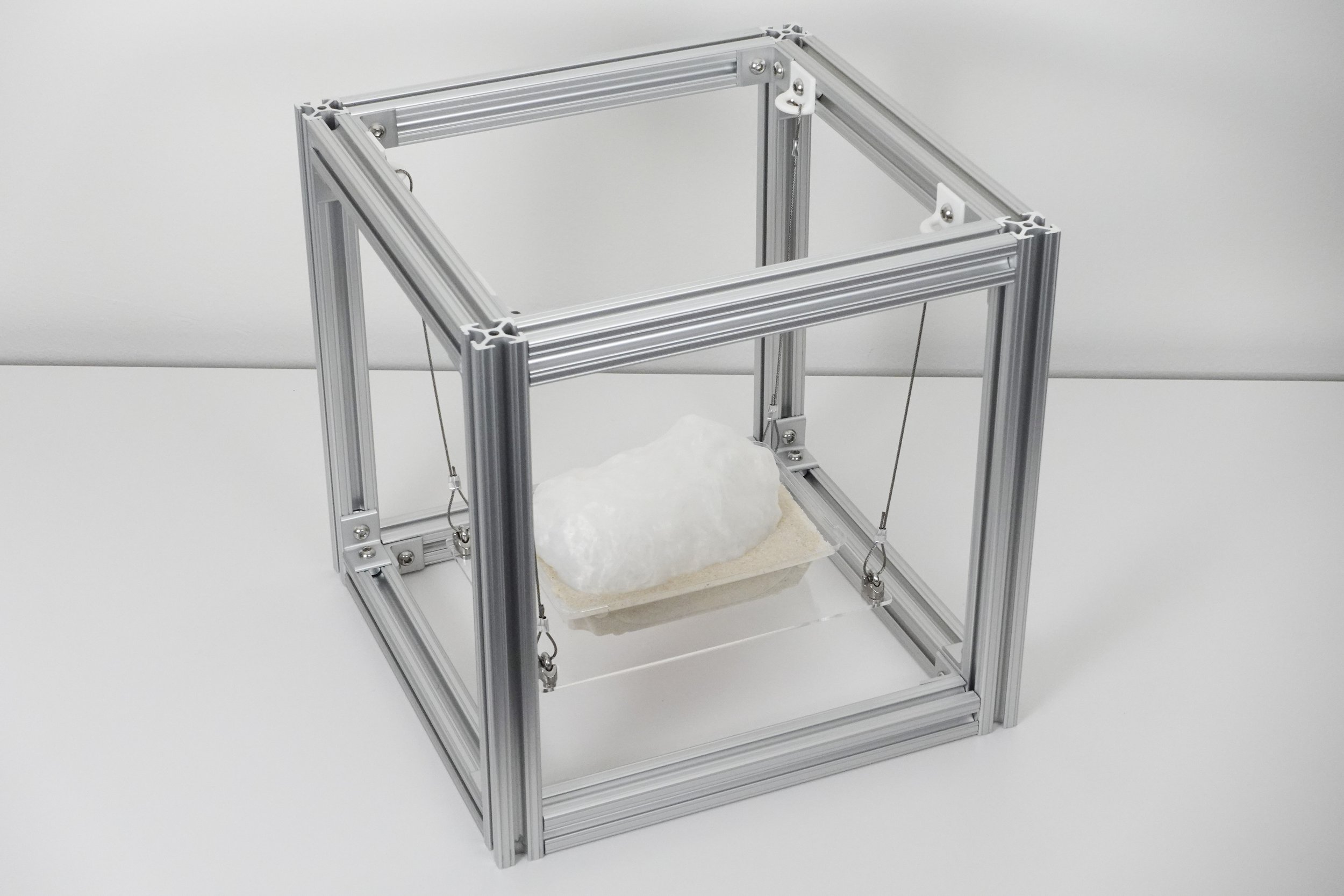 Bollomorpha Titanis, 2025. 3D printed polylactic acid, recycled polyethylene terephthalate, aluminum extrusion, steel cable, acrylic, sand, 12 x 12 x 12 in.