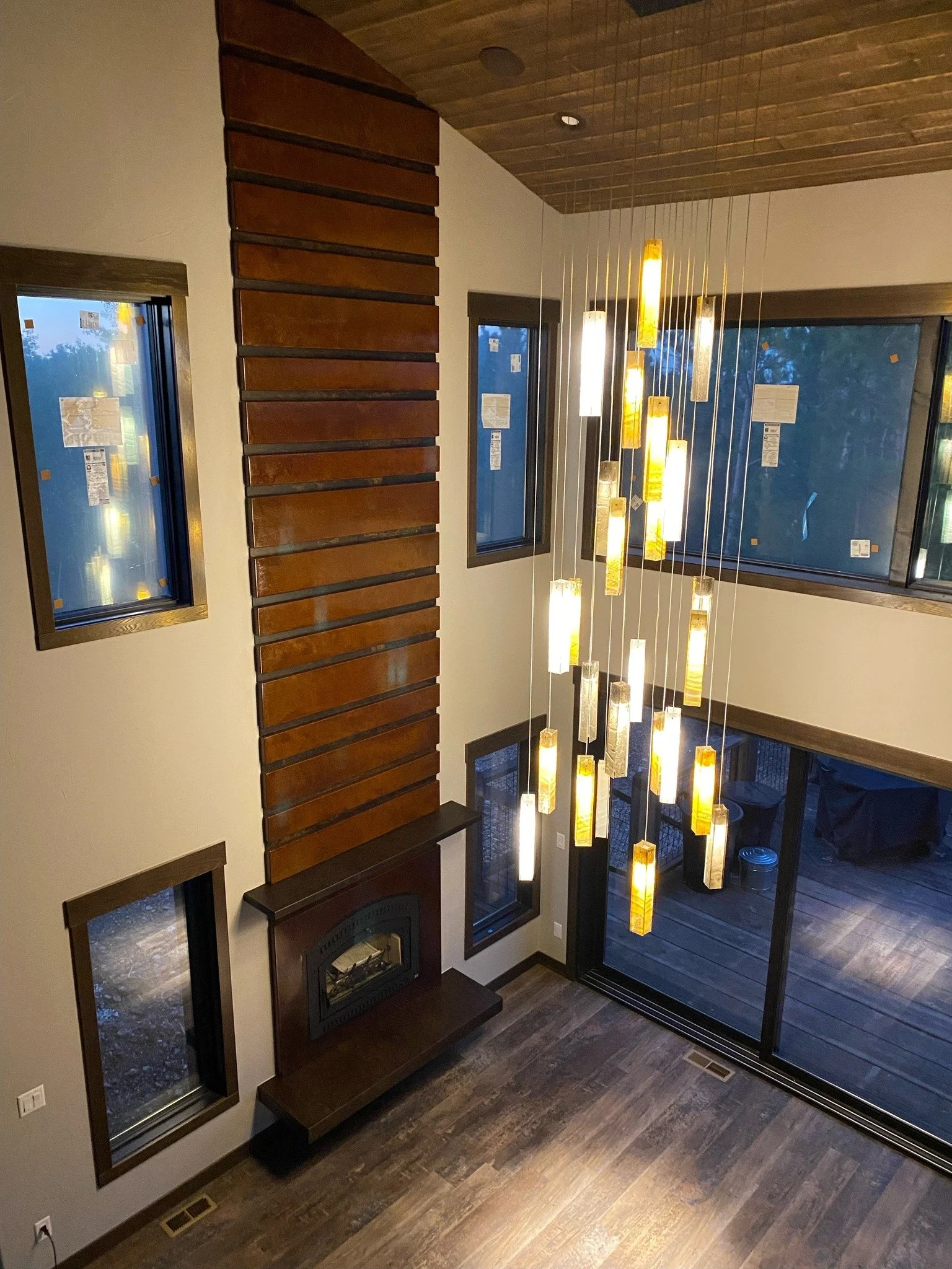 Fireplace design was built by our contractors for a customer in Lead. This fireplace was built using metal and decorative concrete. The fireplace has a floating concrete mantle and hearth. The slats for the fireplace were done in decorative concrete