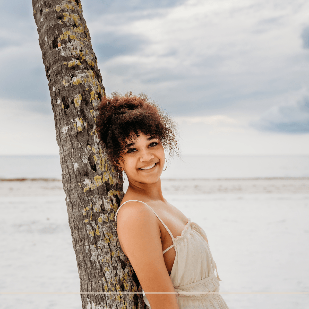 Fort Myers graduating senior poses for senior photography session on fort myers beach