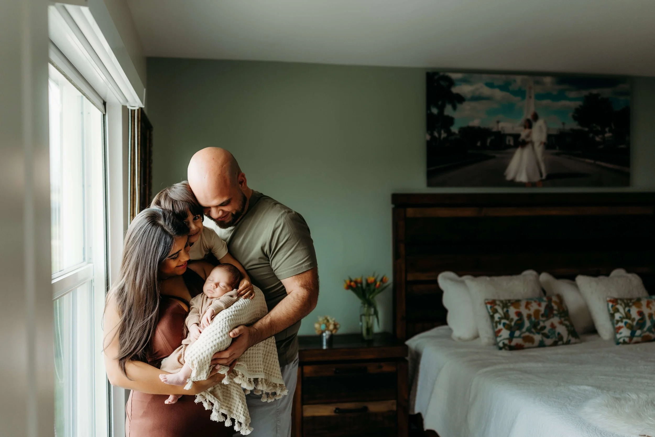 cape coral lifestlye newborn in-home photography family standing with older child and newborn baby boy in bedroom