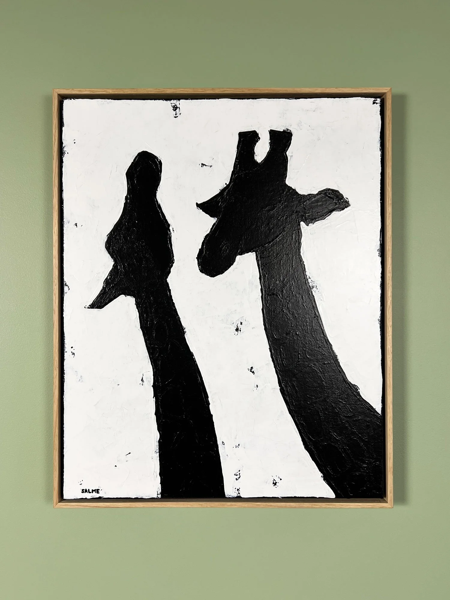 Two black giraffes together against a white background.