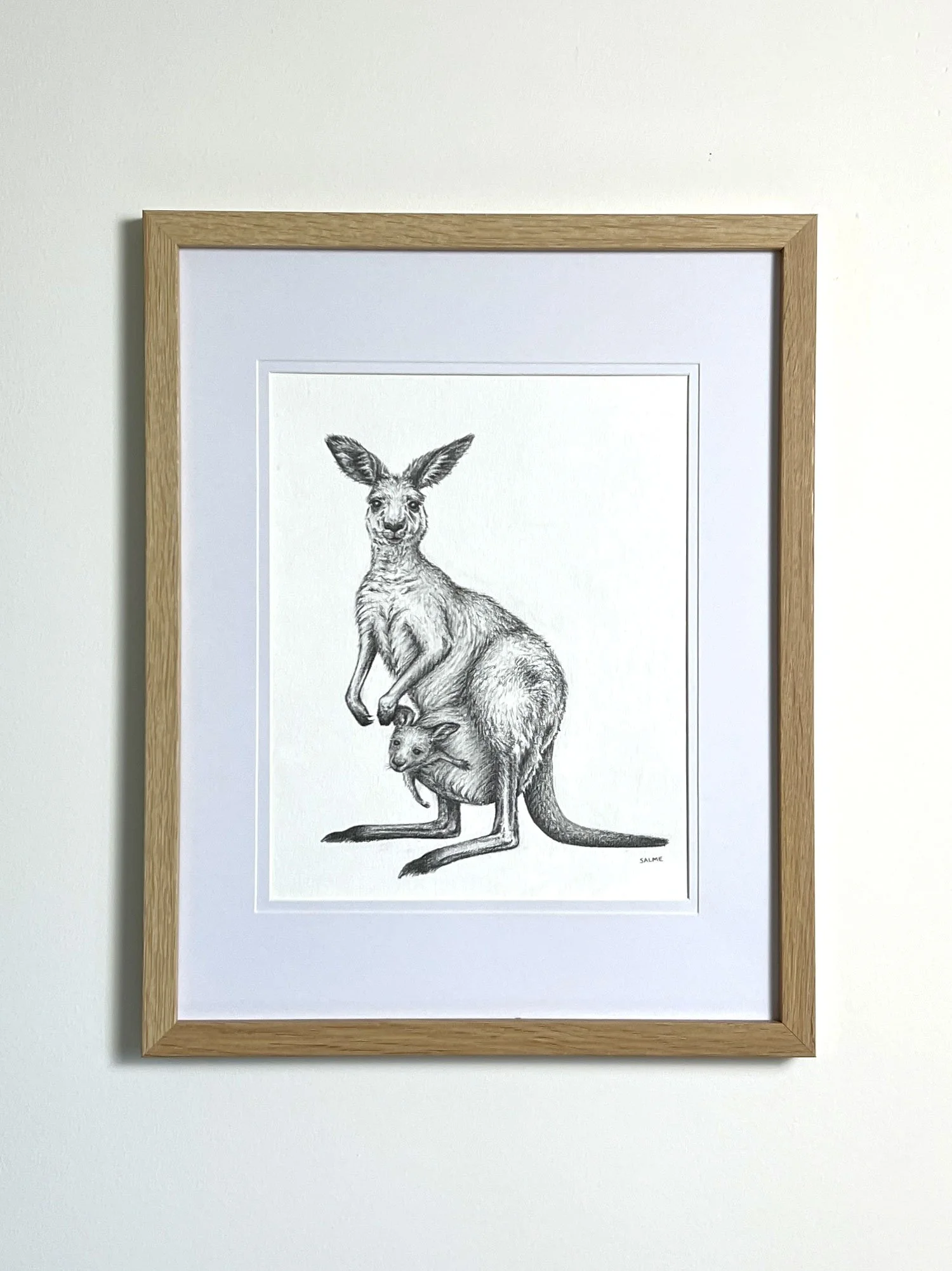 Original graphite drawing of a kangaroo and her joey framed on the wall