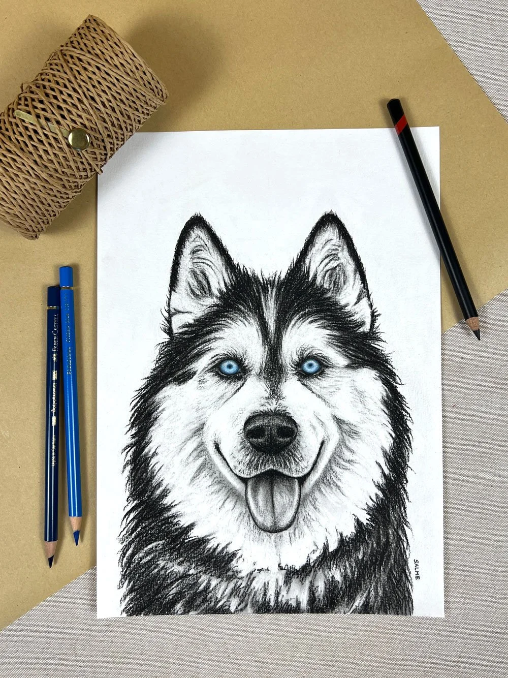 Original charcoal drawing of a husky amongst gift wrapping decoration.