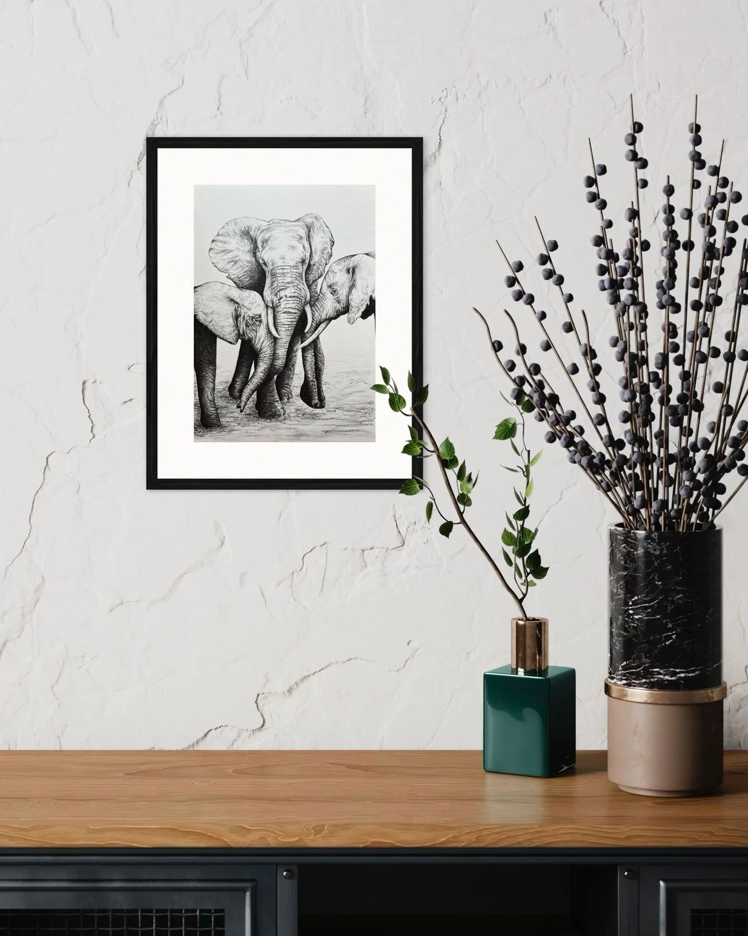A Mother's Love elephant drawing framed and displayed above a hallway table.