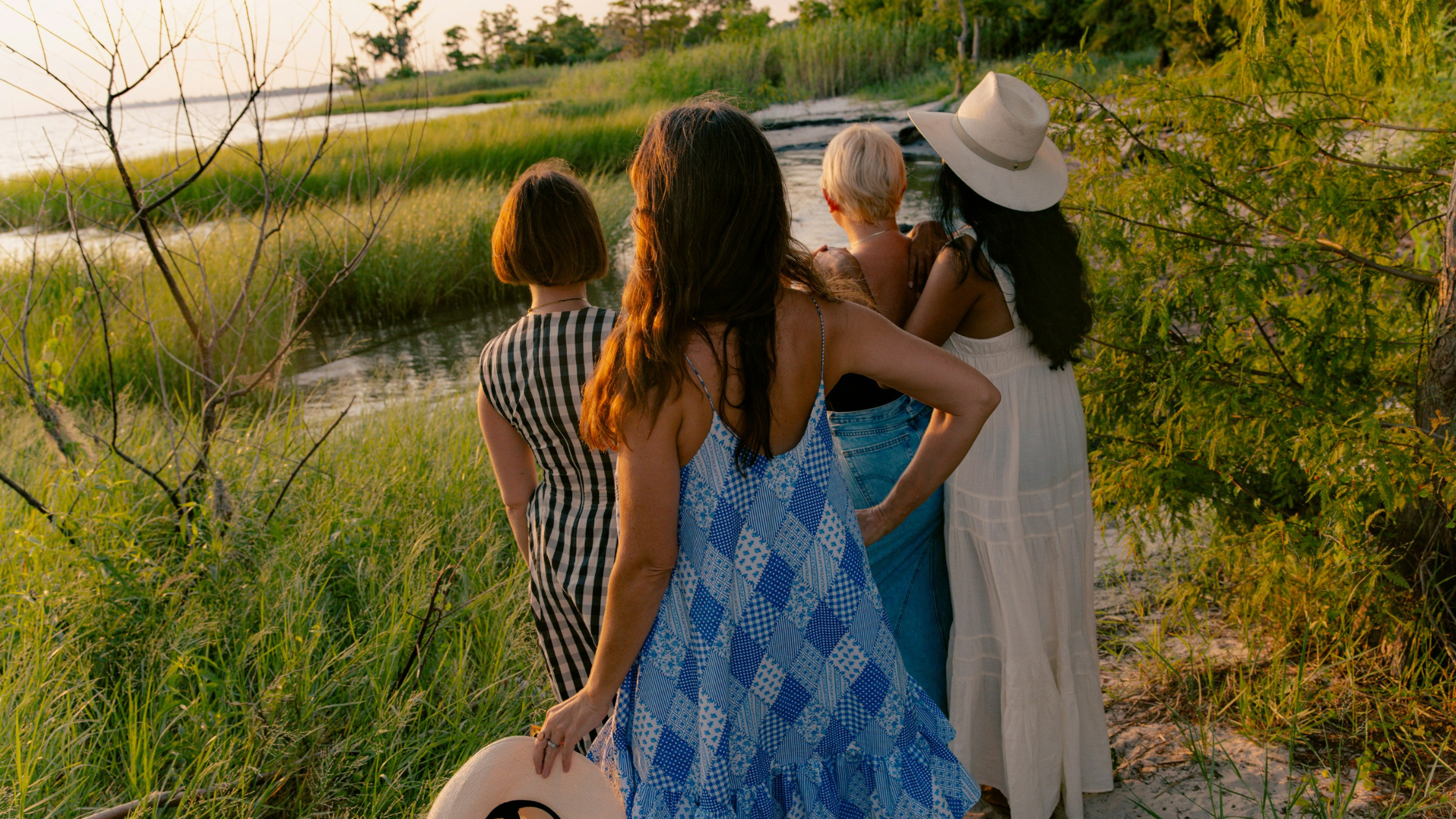 Four women on vacation looking at the sunset