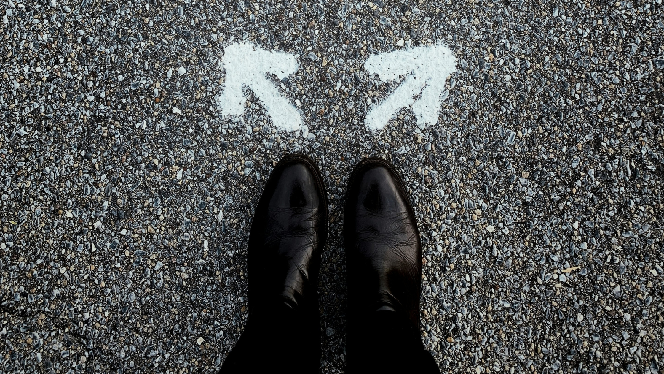 woman's boots standing before two arrows