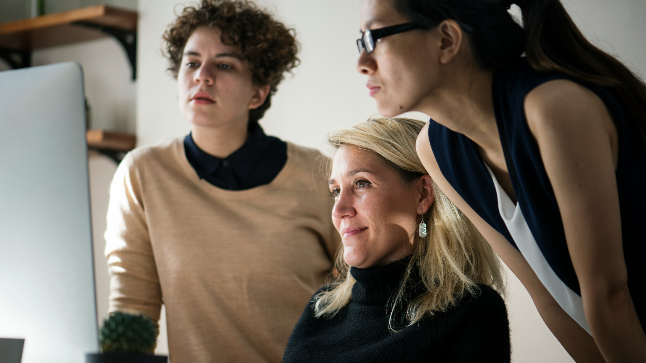 Proud woman showing coworkers a project