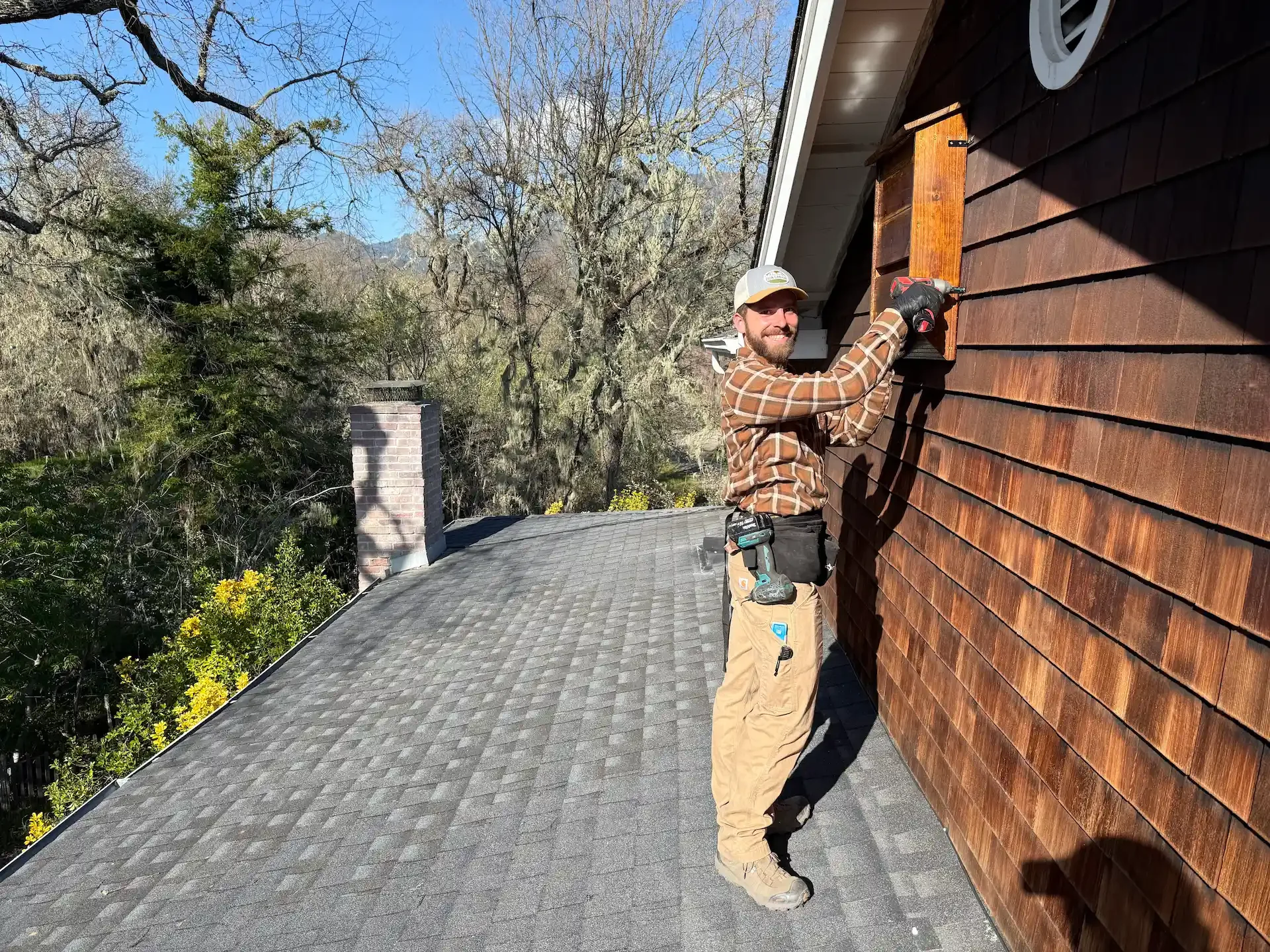 Happy Bat Solutions technician installing bat house