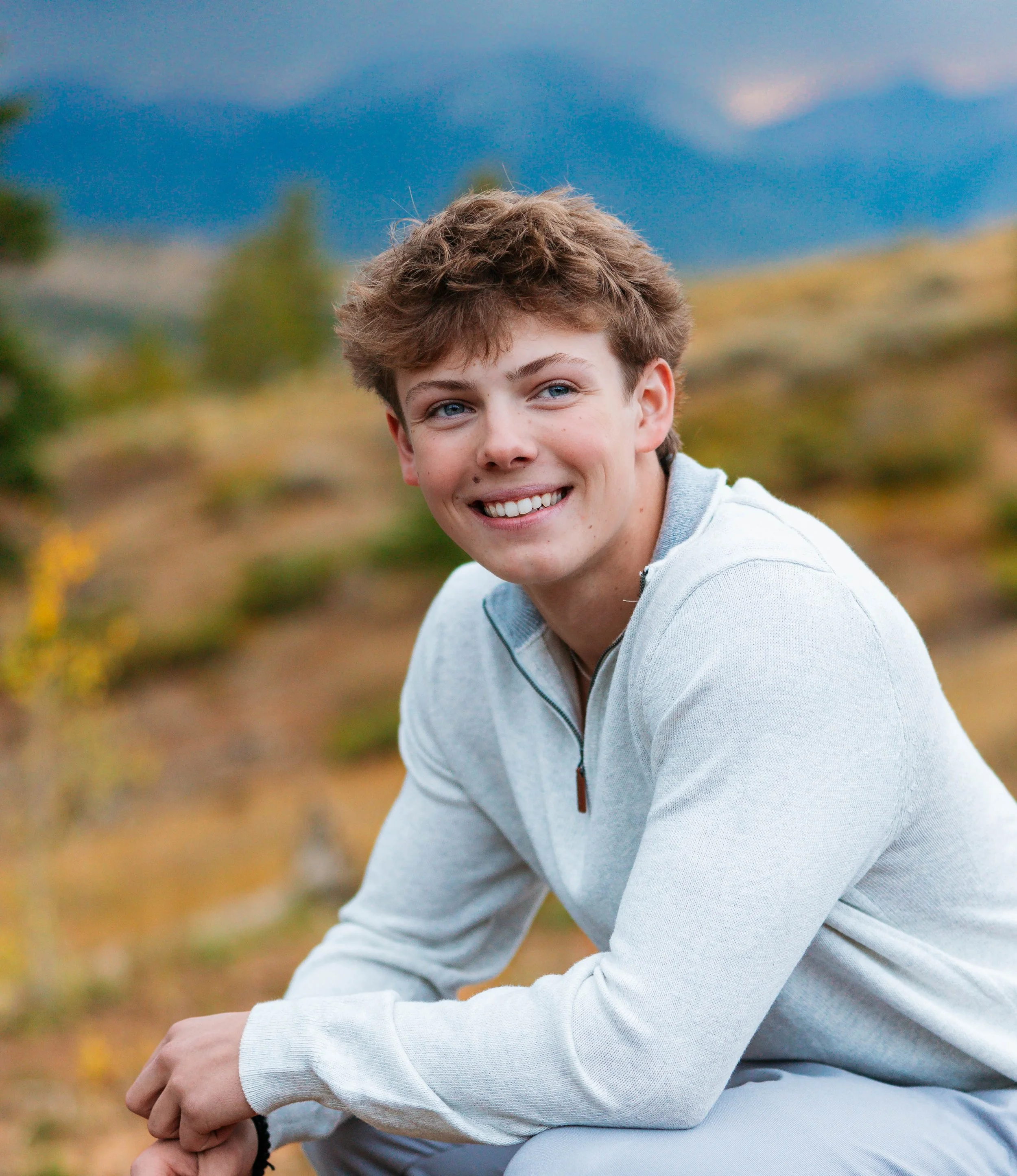High school senior posing in front of mountain