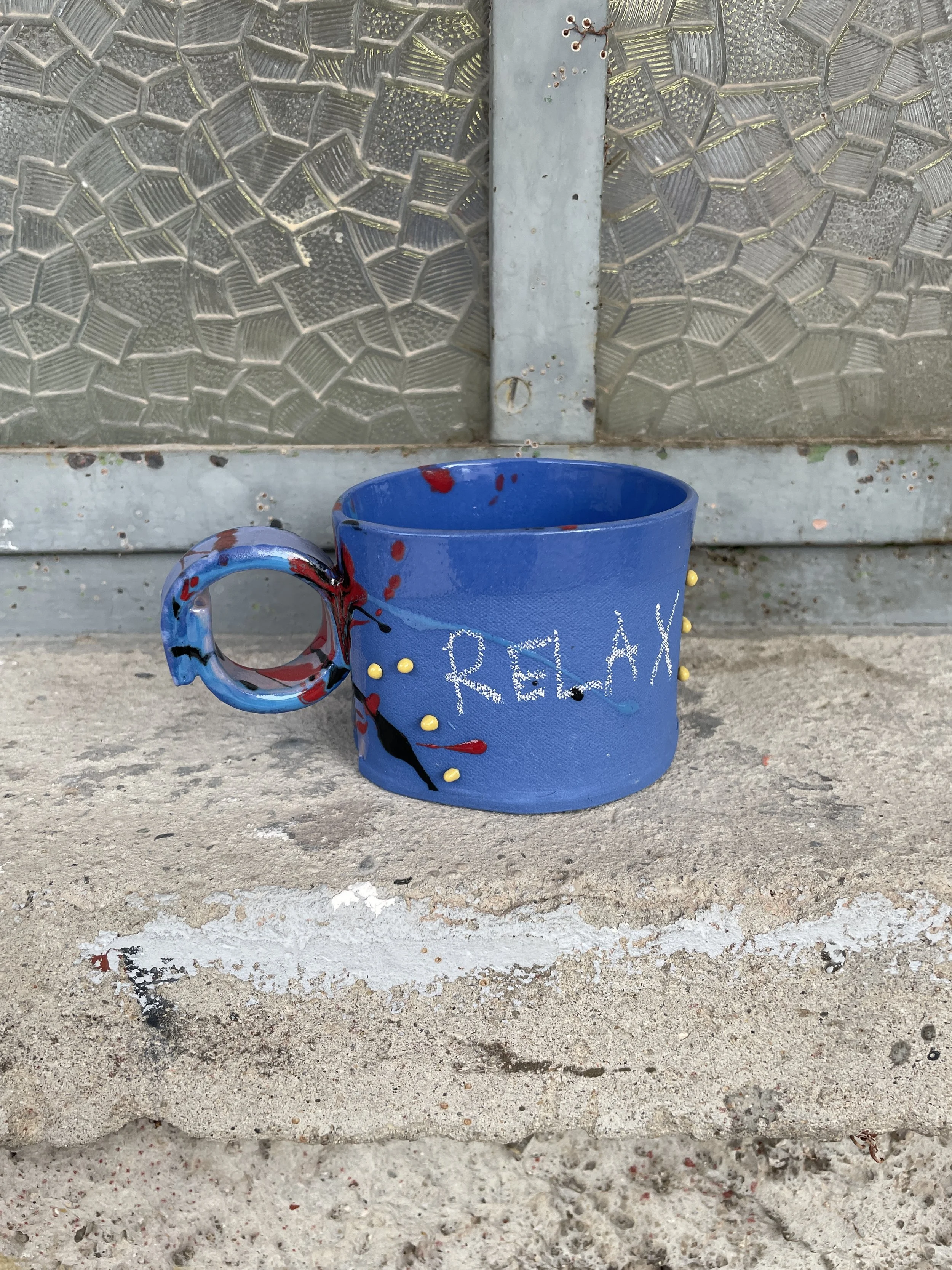 Funky handmade ceramic mug showing side detail and handle.JPG