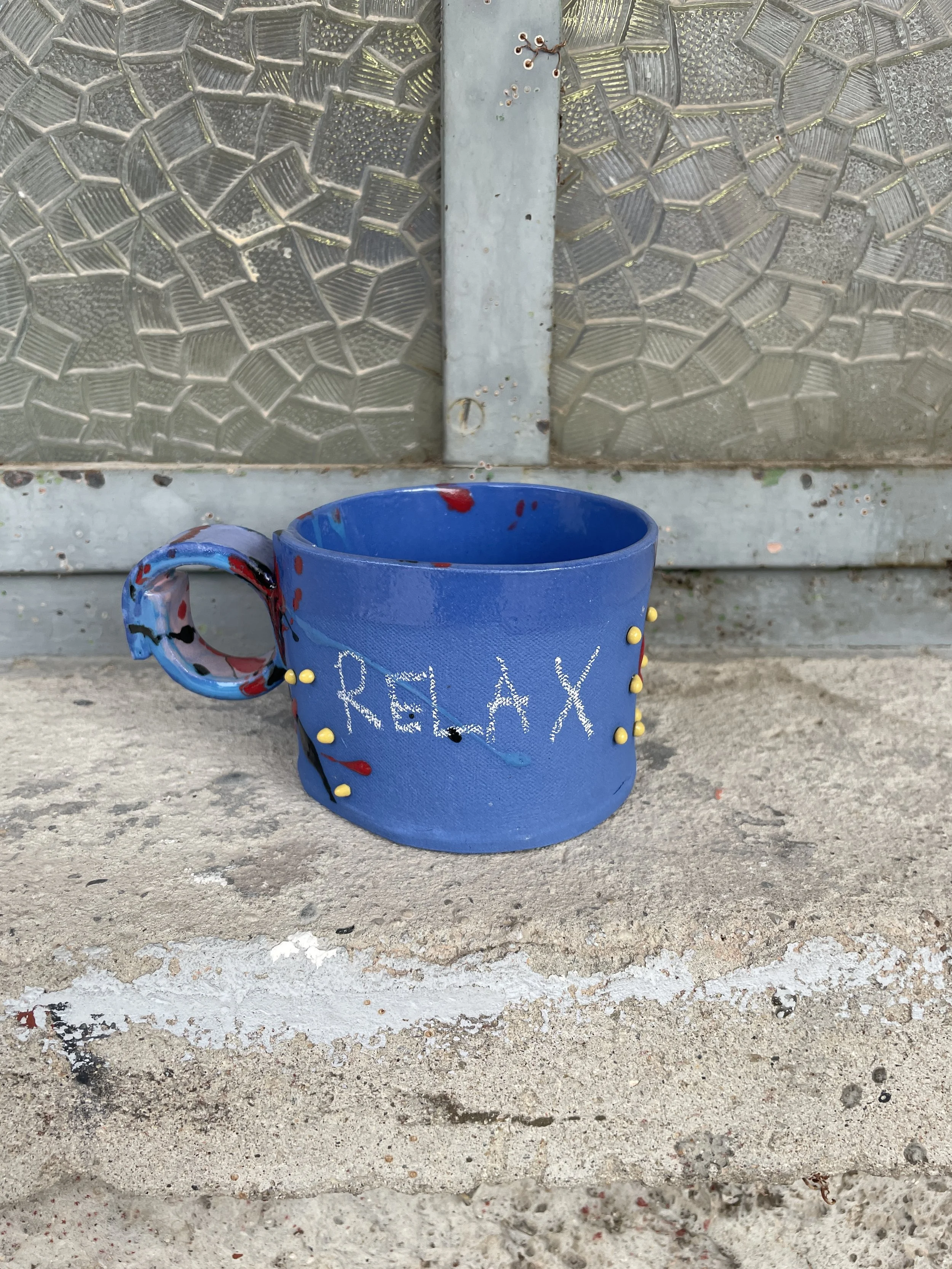 Hand-painted blue porcelain espresso cup with Relax lettering.JPG