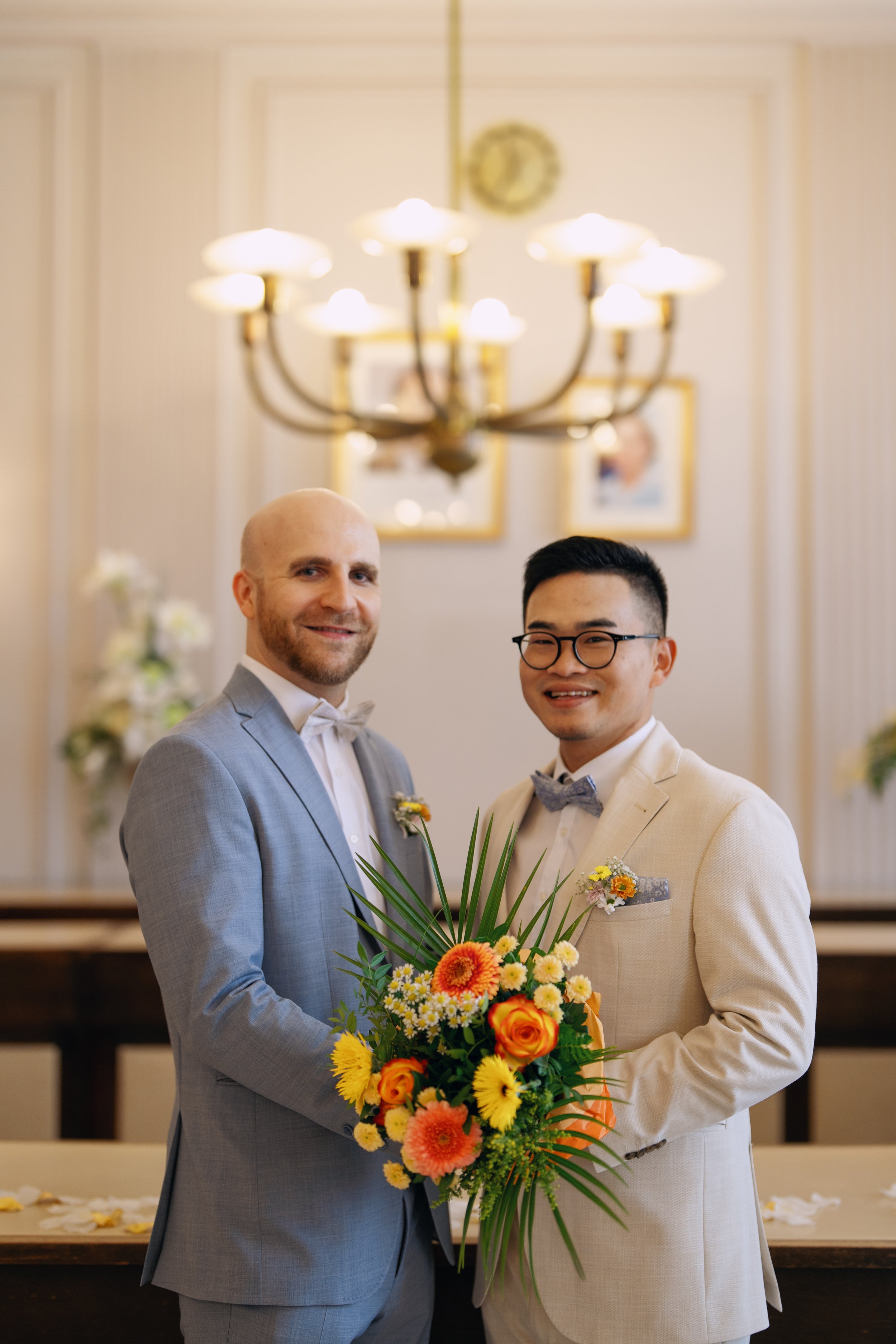 Two grooms holding their wedding bouquet after the civil wedding ceremony.