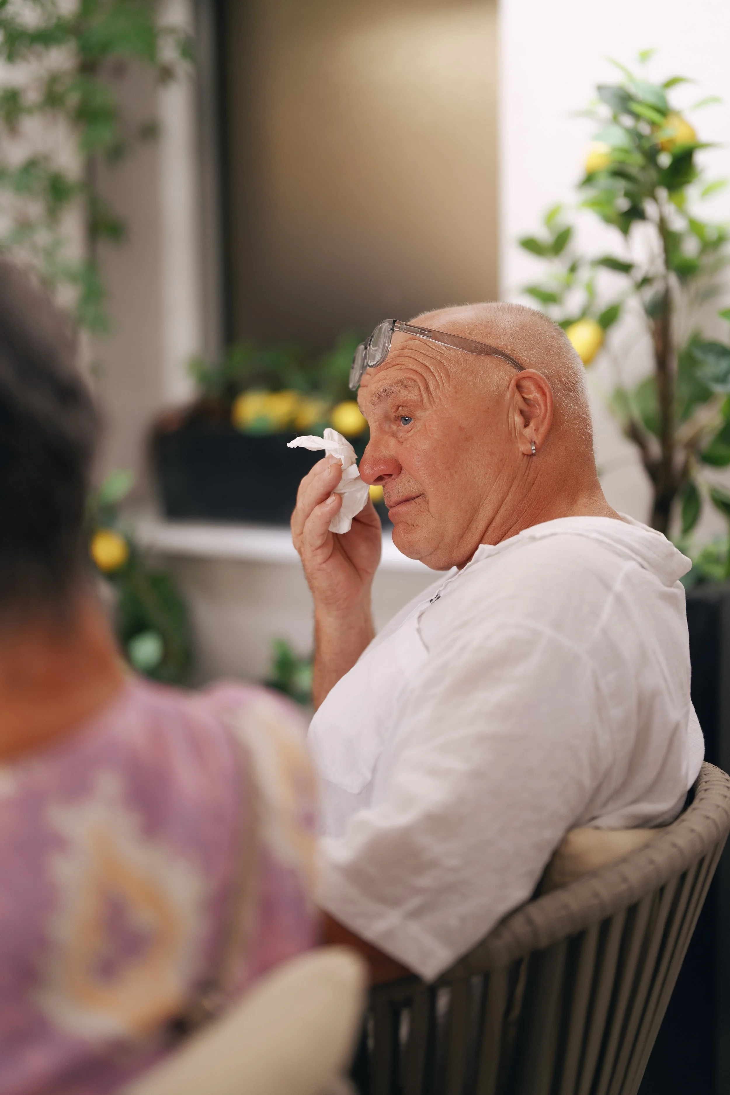 An elderly guest enjoying the wedding reception.