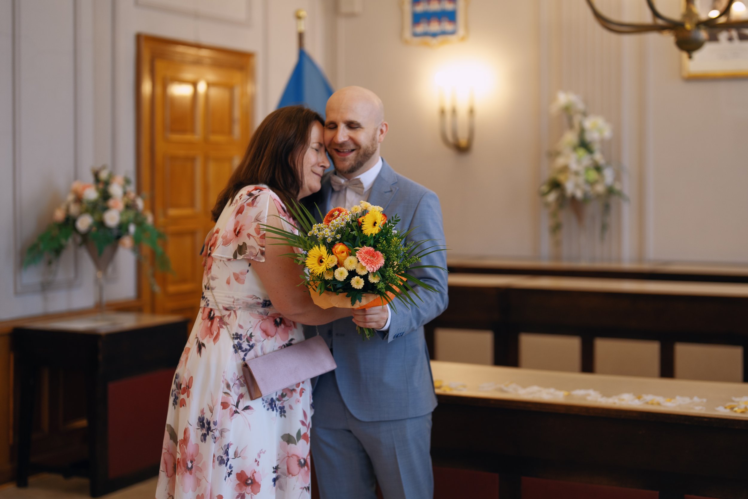 One groom sharing an emotional hug with his mother after the ceremony.