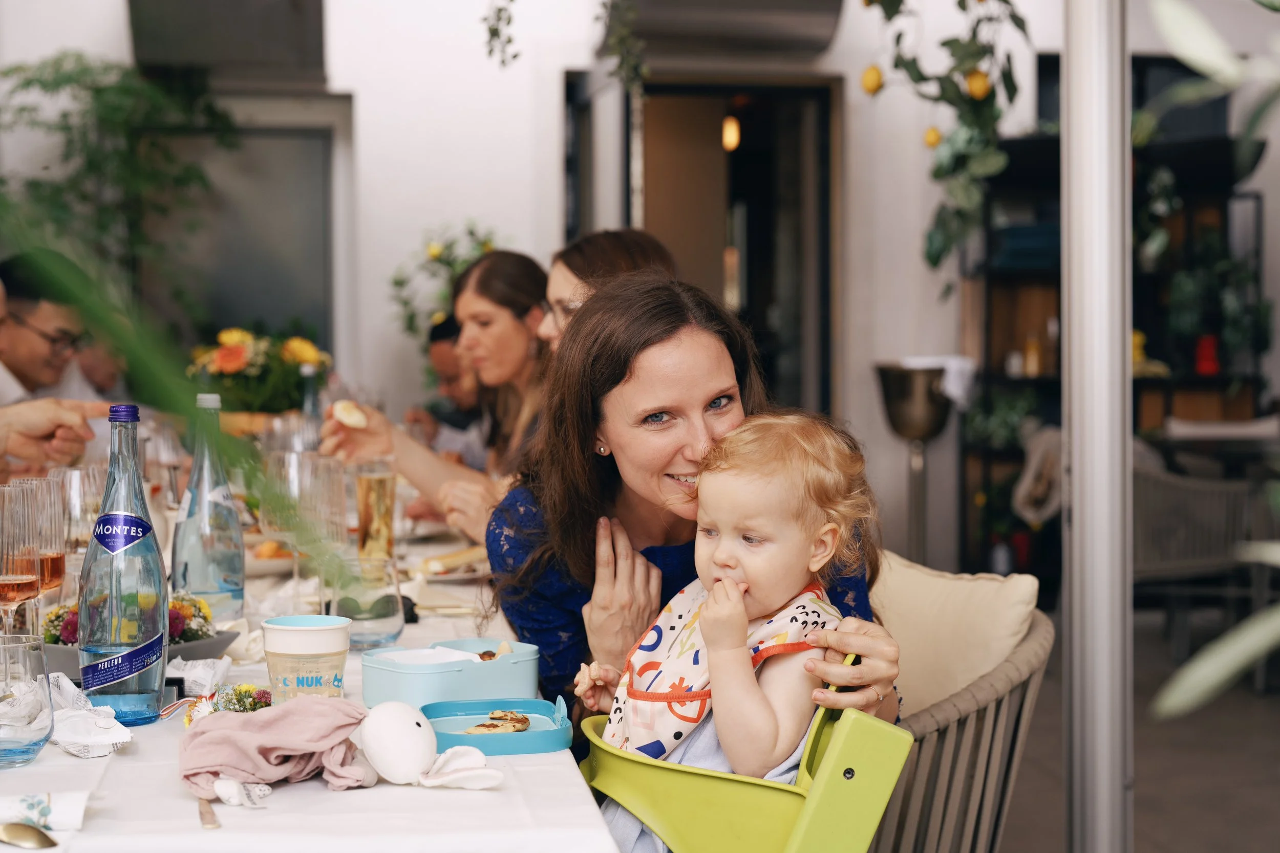 A mother smiling at her daughter during the wedding reception.