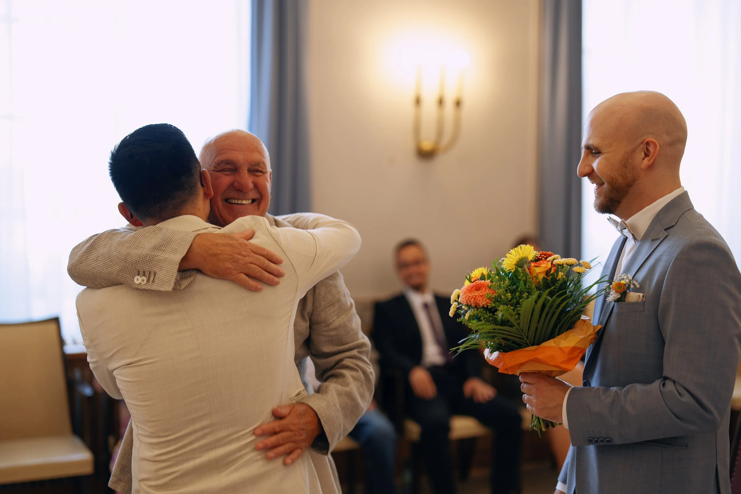 An emotional family hug after the civil wedding ceremony.