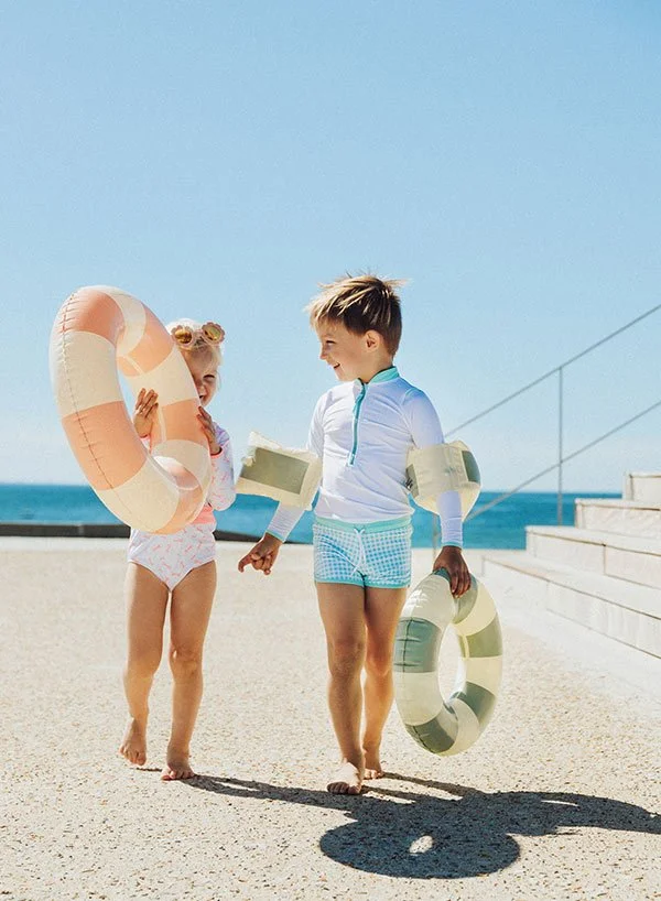 Deux enfants jouent à la plage avec leur maillots de bain Poppy and Sea