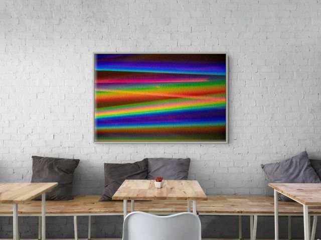 Colorful abstract striped artwork above a wooden bench and tables in a modern café with white brick walls