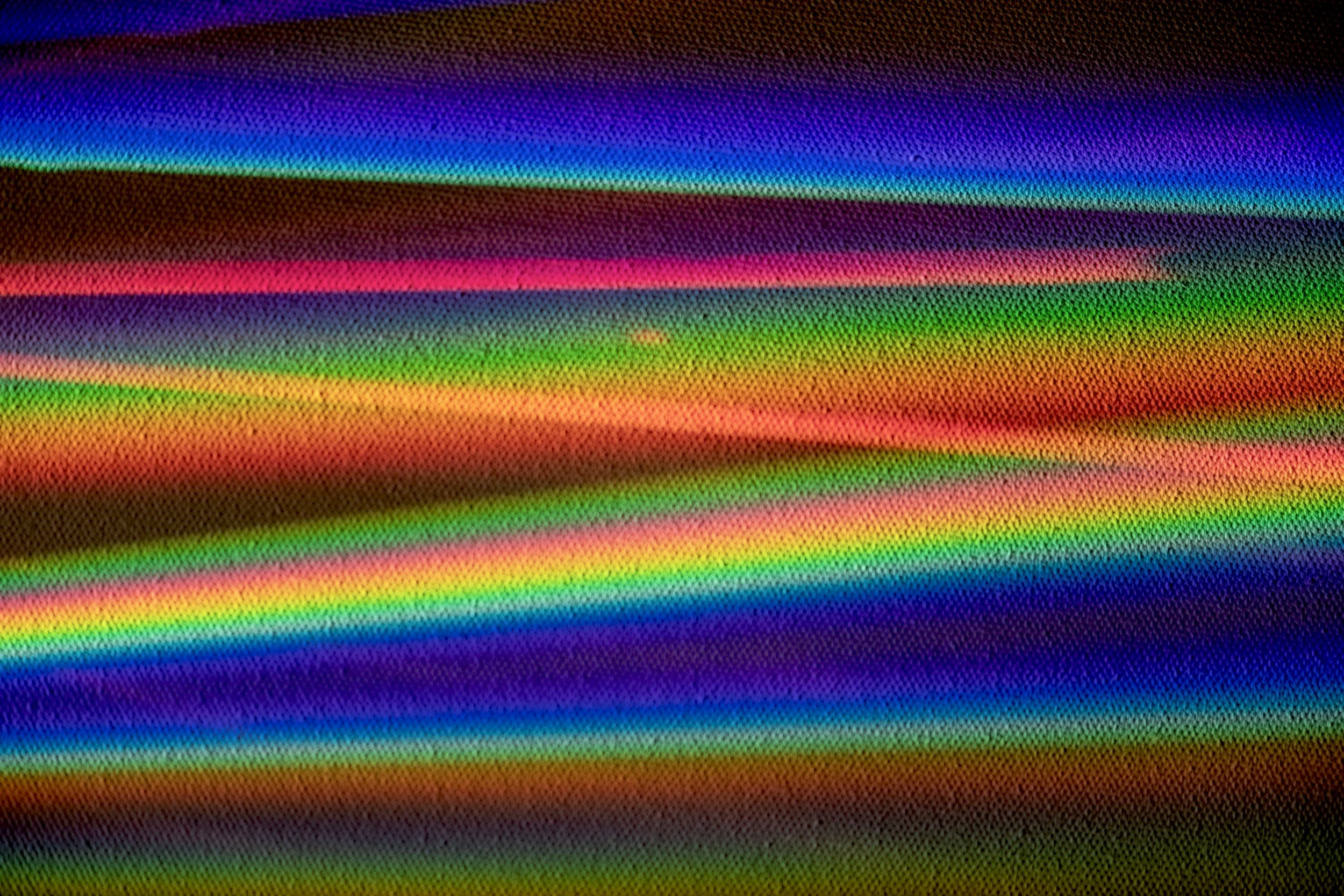 Abstract multicolored rainbow gradient with horizontal bands and textured pixel pattern