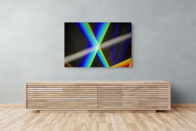 Modern living room with abstract colorful light-beam artwork above a wooden slatted credenza