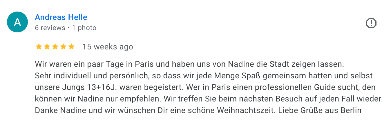 Review from Andreas Helle, five-star rating, written in German, describing a trip to Paris with Nadine, visiting the city and exploring with a guide, expressing satisfaction and holiday greetings.