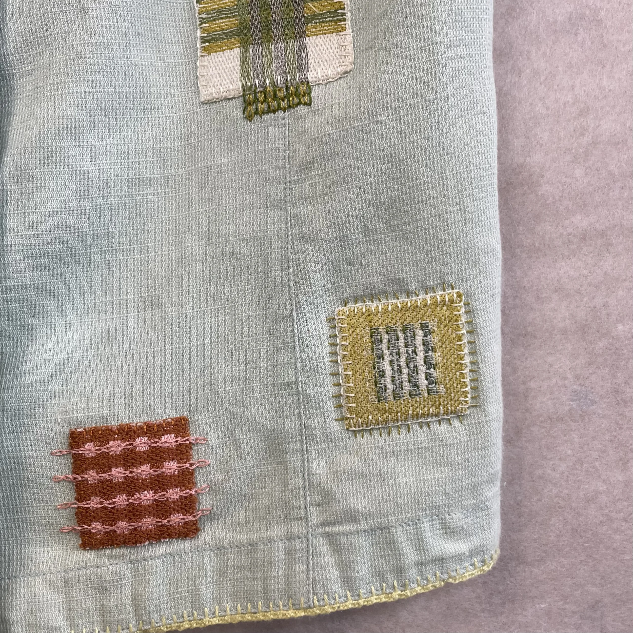 Close-up of fabric with embroidered patches in different colors and patterns