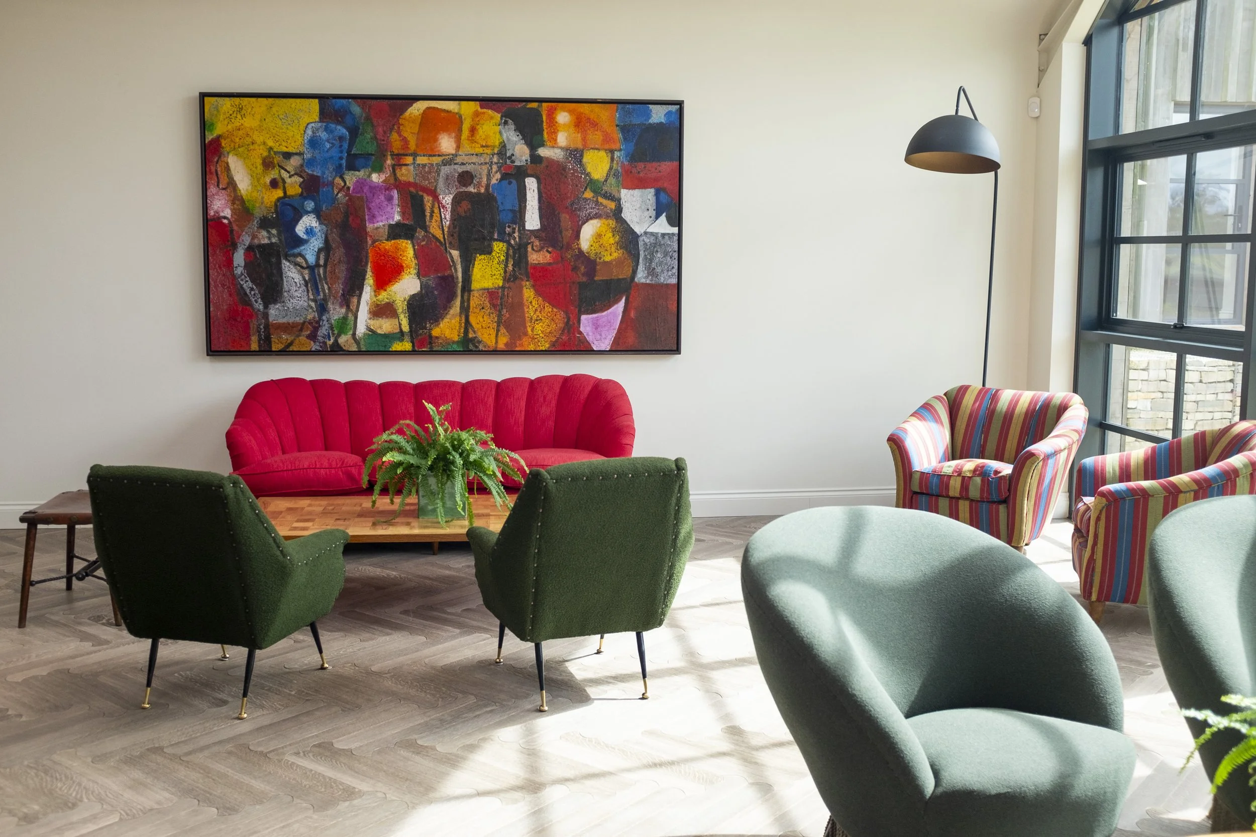Modern living room with colorful abstract painting and furniture