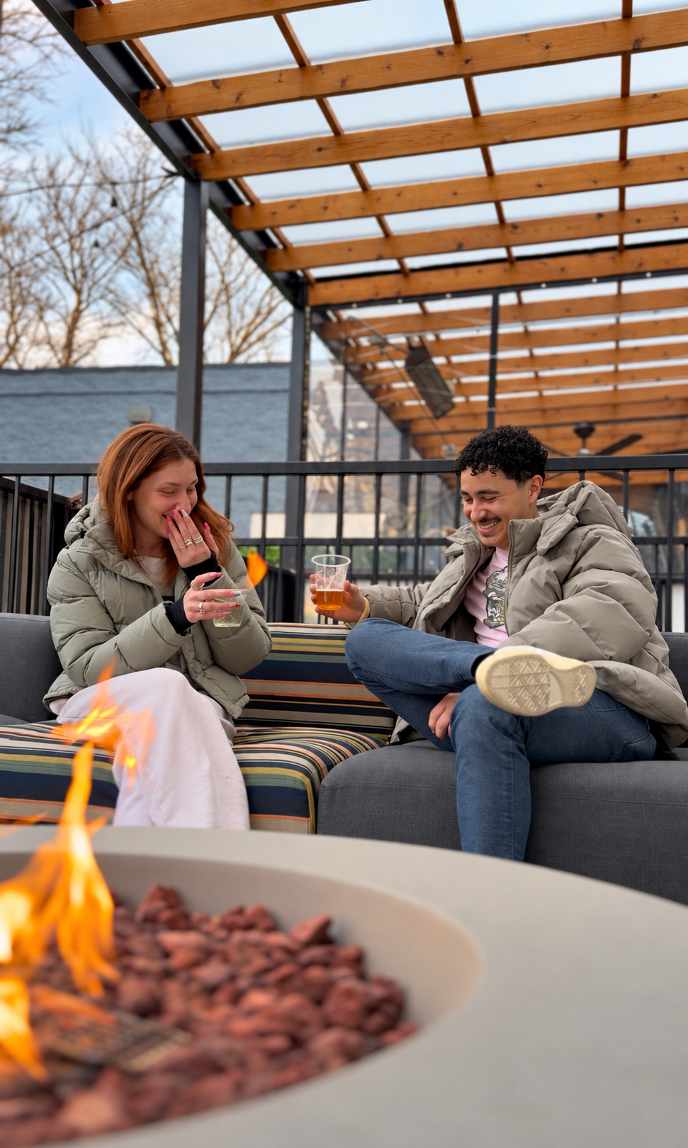 Cozy firelit portrait of two friends.png