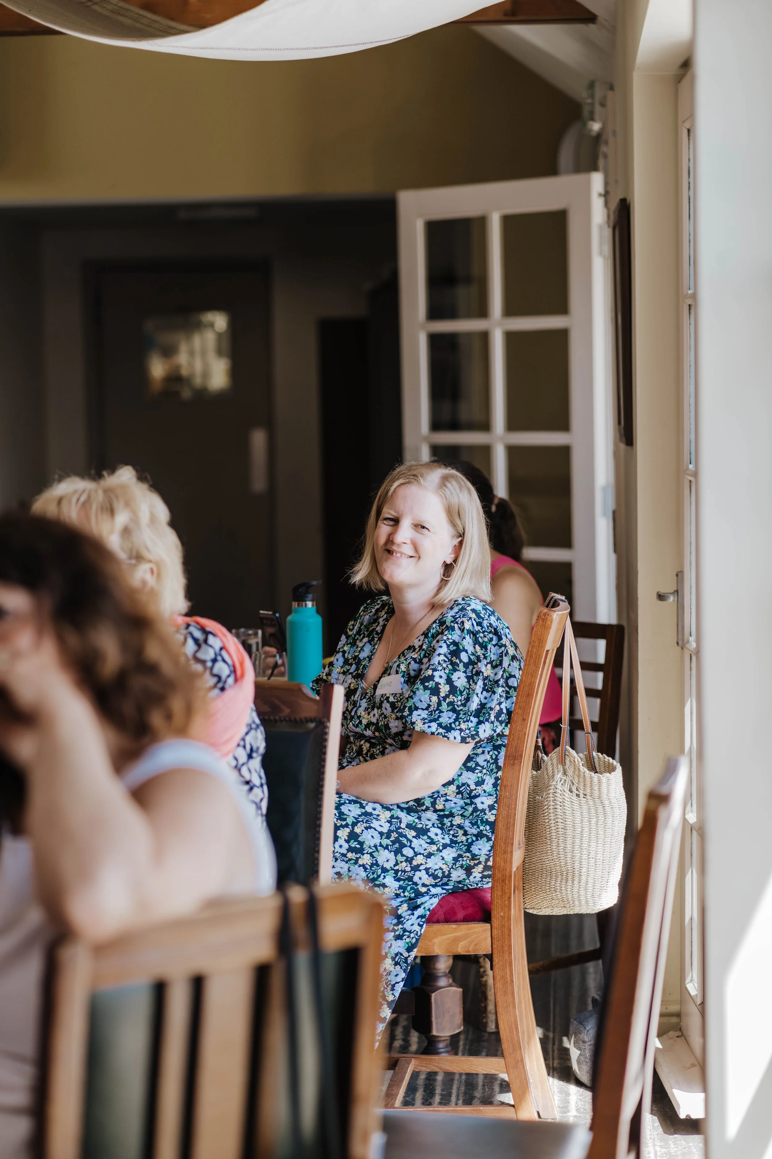 Gemma Gooch smiling and chatting with other business owners at a Women Inspired Network event