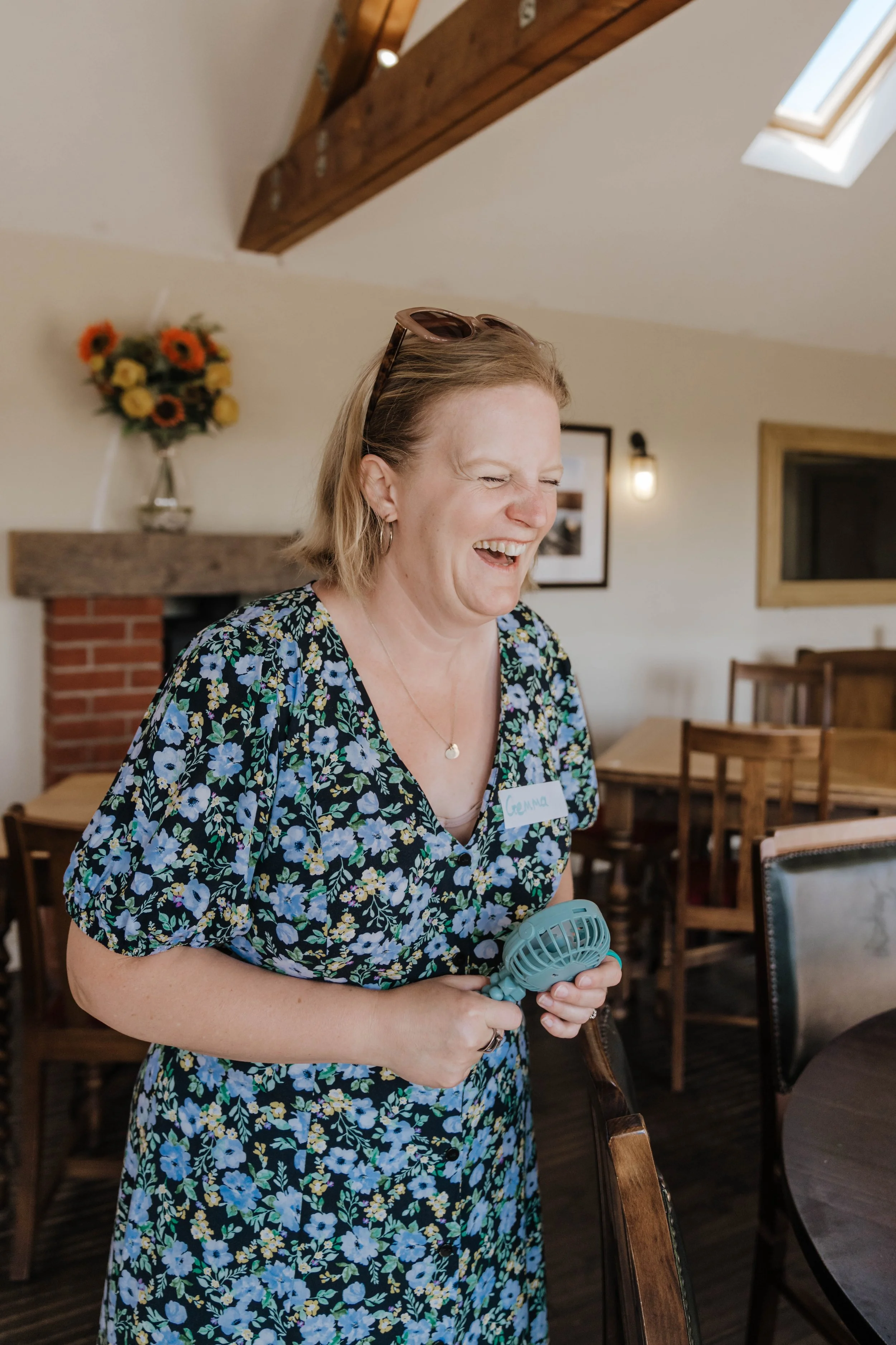 Gemma Gooch laughing while chatting with someone at a networking event