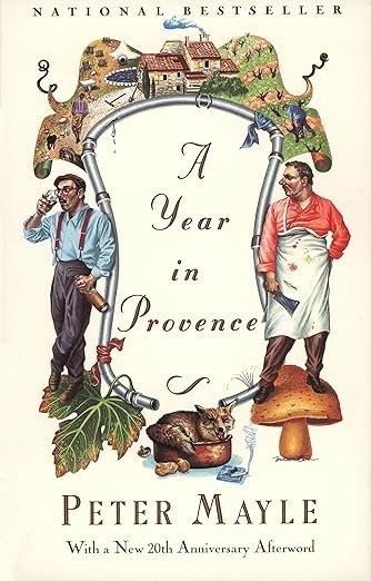 Book cover titled 'A Year in Provence' by Peter Mayle, featuring illustrations of a village, two men in traditional clothing, a cat, and a large mushroom.