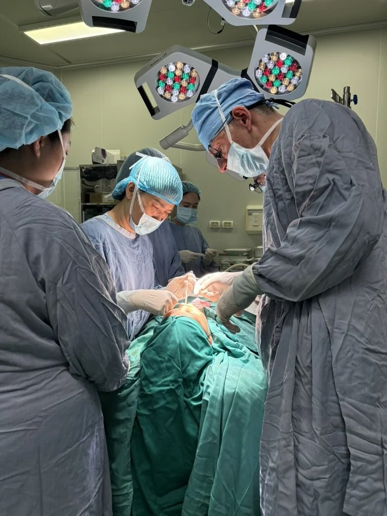 Mr Bast and his team performing nose surgery in scrubs and PVC in the operating room