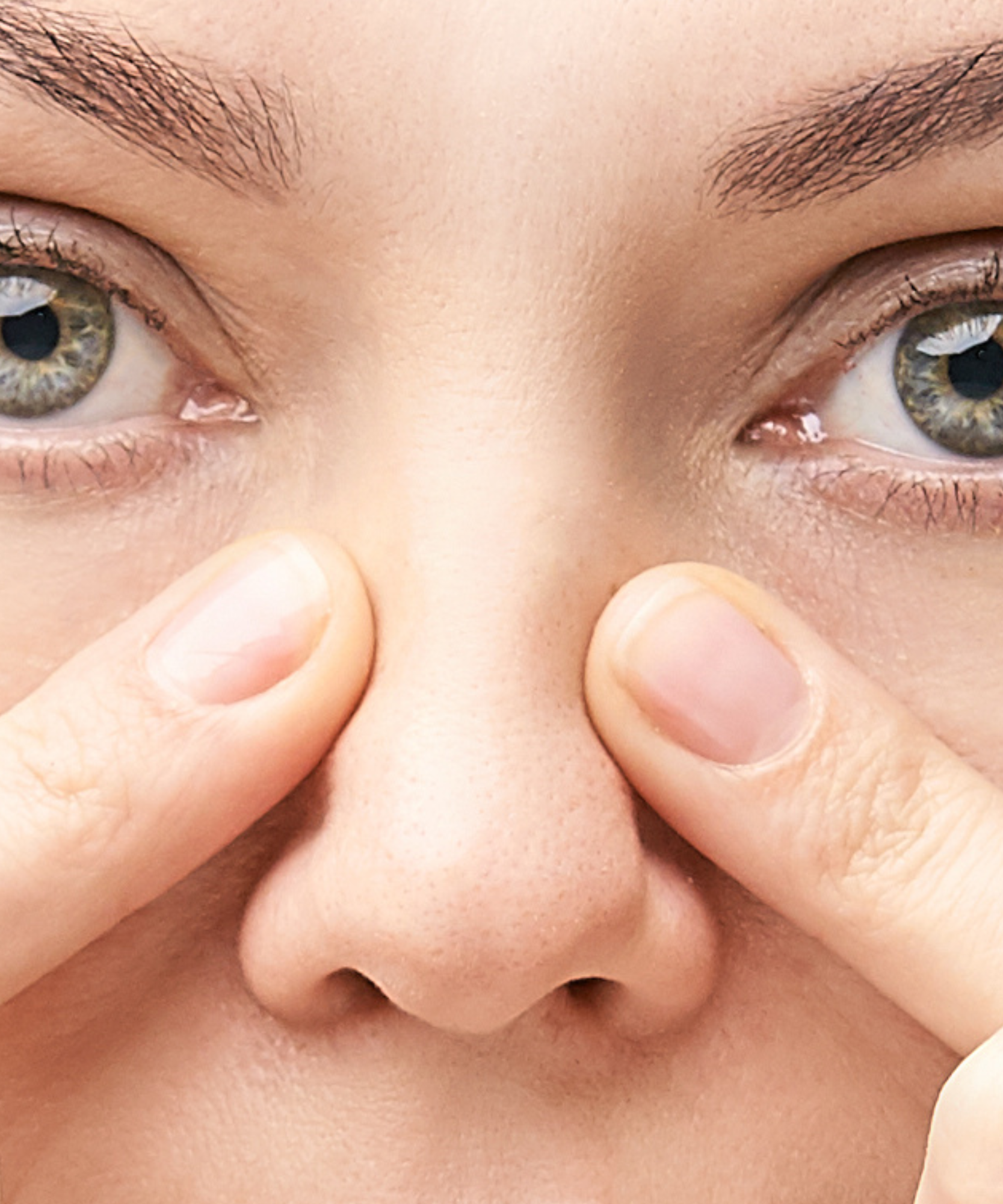 woman holding her nose