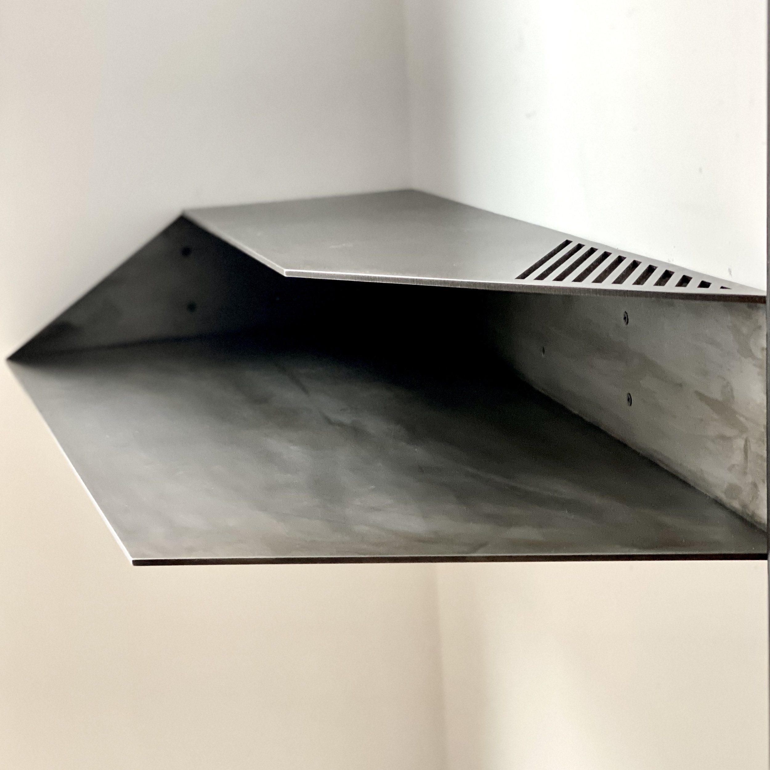 Wall mounted corner desk.
Lacquered Blackened Steel
35" x 17"x 5.5" h