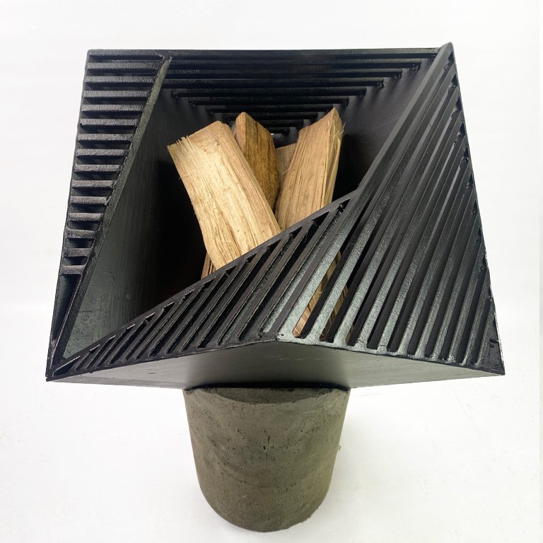 Introducing Viewpoint - Firepit, a modern and sleek addition to your outdoor space. Handmade with steel and concrete for an angular, geometric design that provides a unique perspective on fire. The slits allow light to shine through, creating a mesme