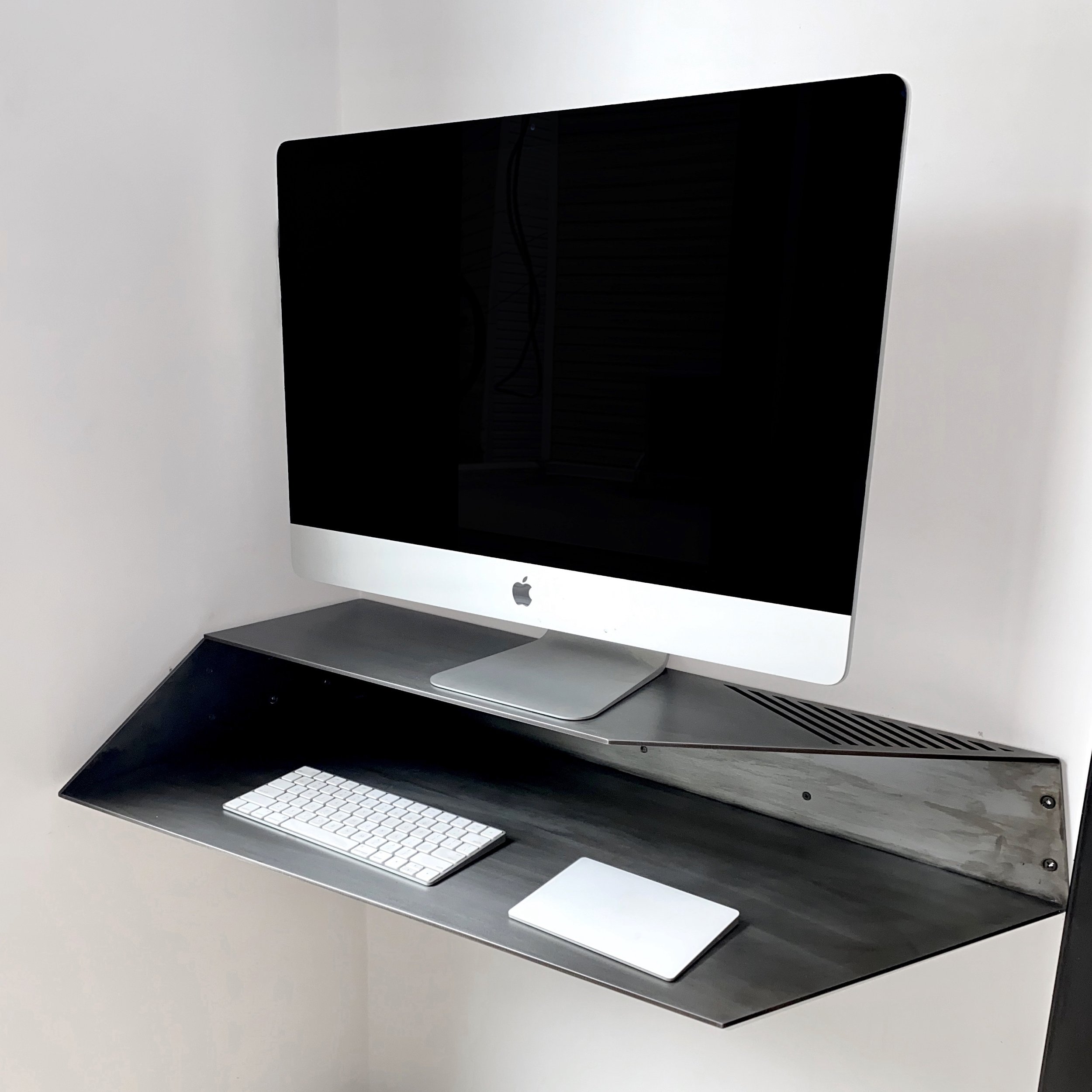 Wall mounted corner desk.
Lacquered Blackened Steel
35" x 17"x 5.5" h