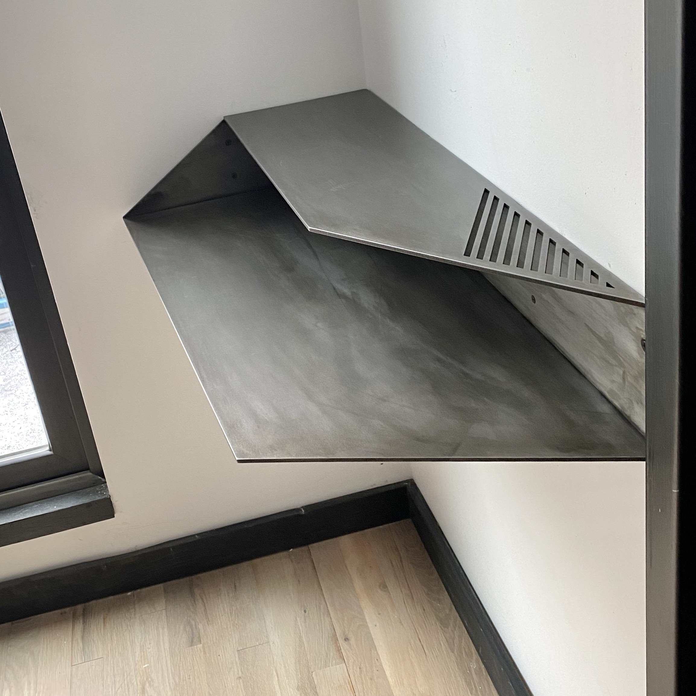 Wall mounted corner desk.
Lacquered Blackened Steel
35" x 17"x 5.5" h