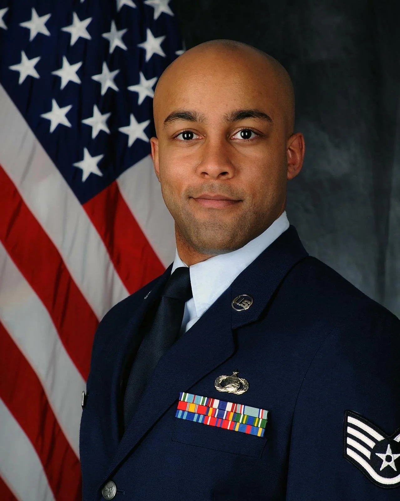 Portrait of the author in U.S. military dress uniform with a canted flag in the background