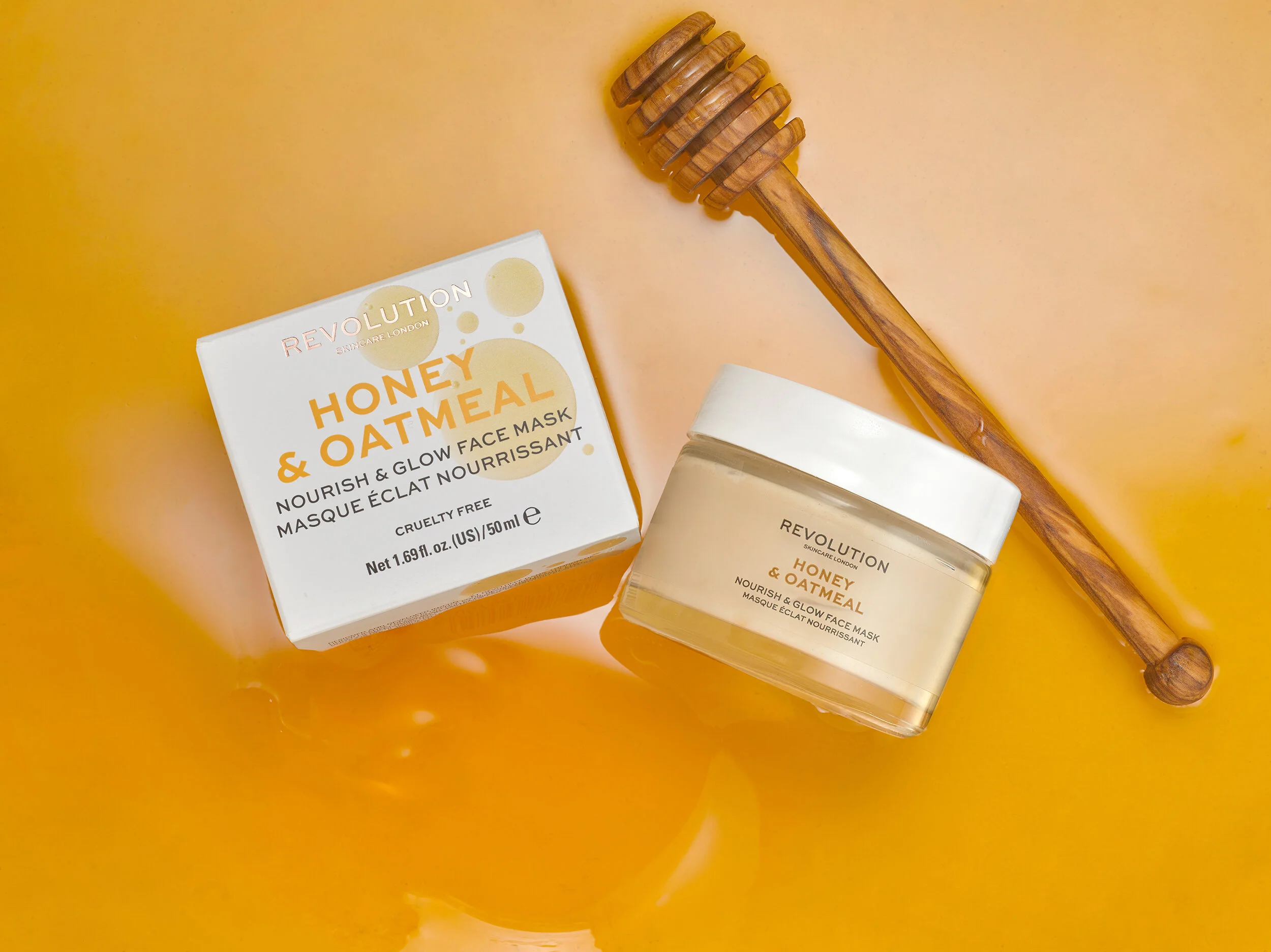 Beauty cosmetic cream in small jar with box and honey stirrer. Creative still life photography with product sitting in a swirl of honey. Created in london photography studio by chris howlett (Copy)