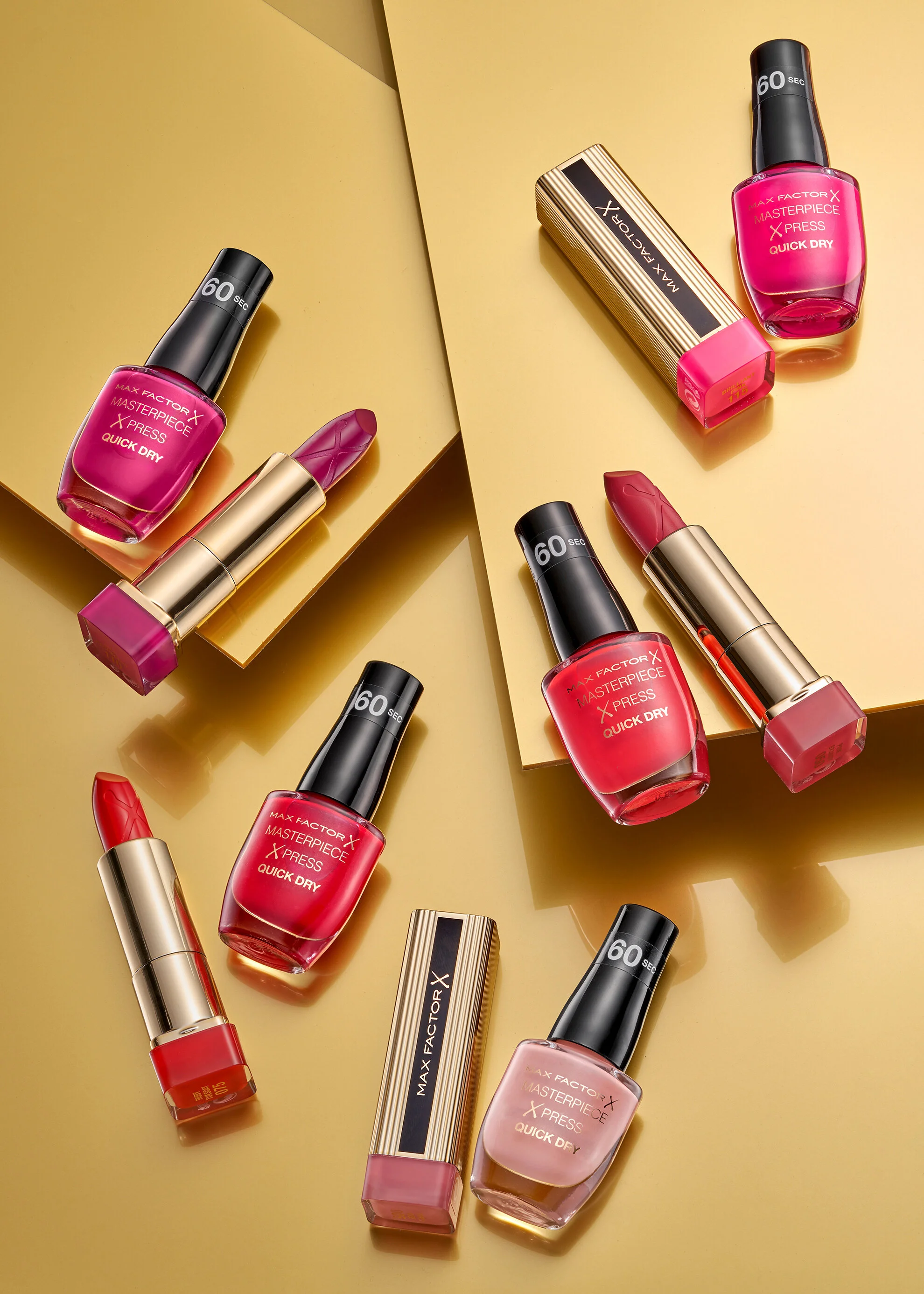 Beauty products placed on gold background. All nail varnishes and lipsticks. Still life photographer chris howlett from london (Copy)