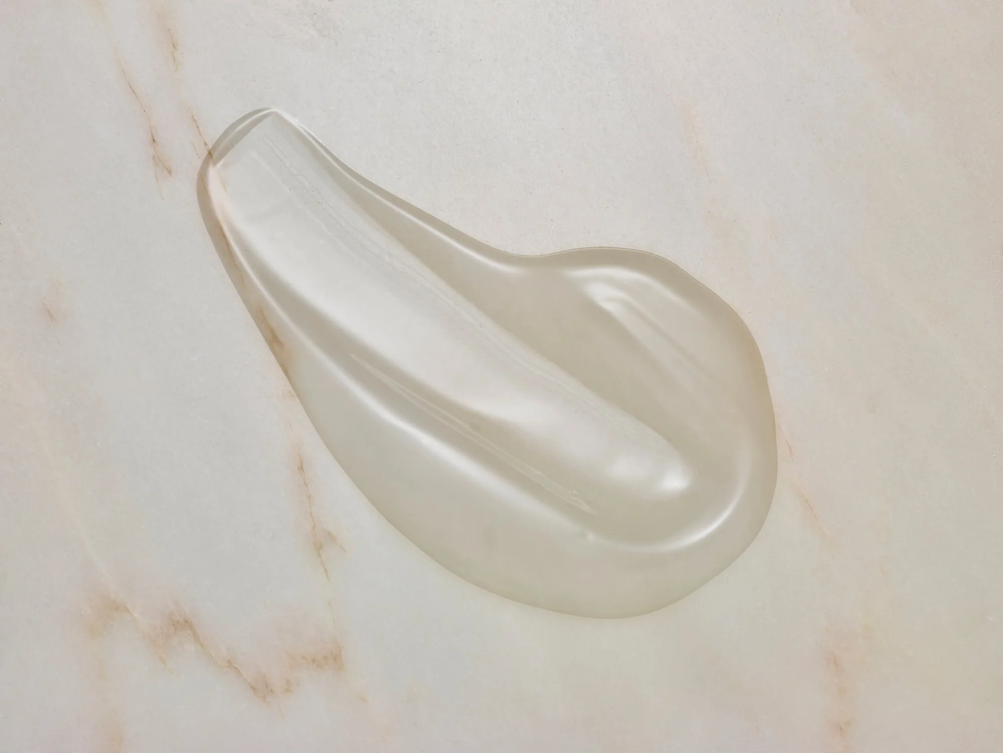 moisturiser cream in swatch shape on marble tile